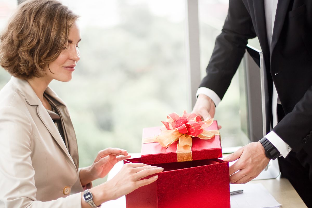 A beautiful woman getting work anniversary gift from her boss