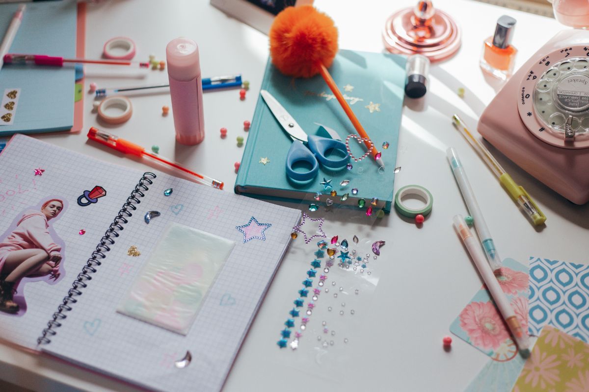 A lady making sticker at home by herself by using stationary items.