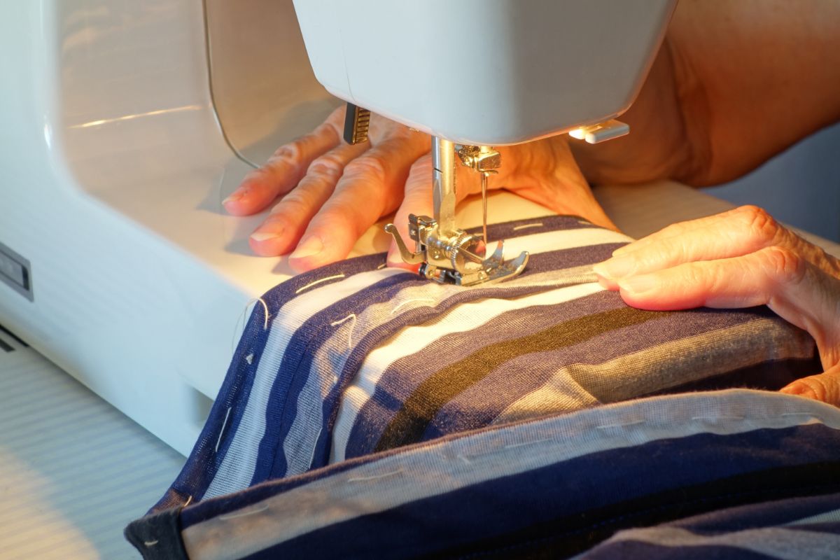 A man sewing a t shirts