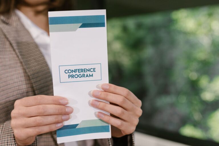 A women holding business flyer designed by her.