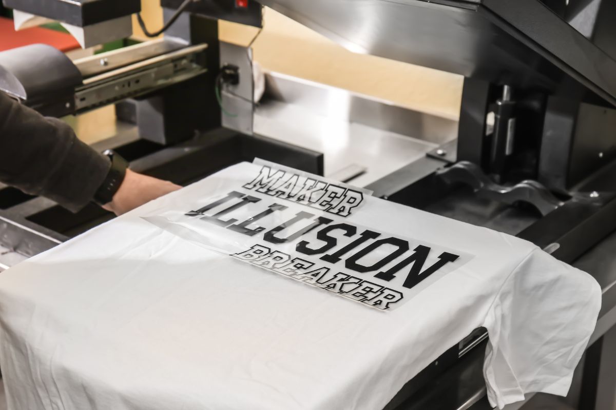 Person designing t shirt on the machine  to start t shirt business