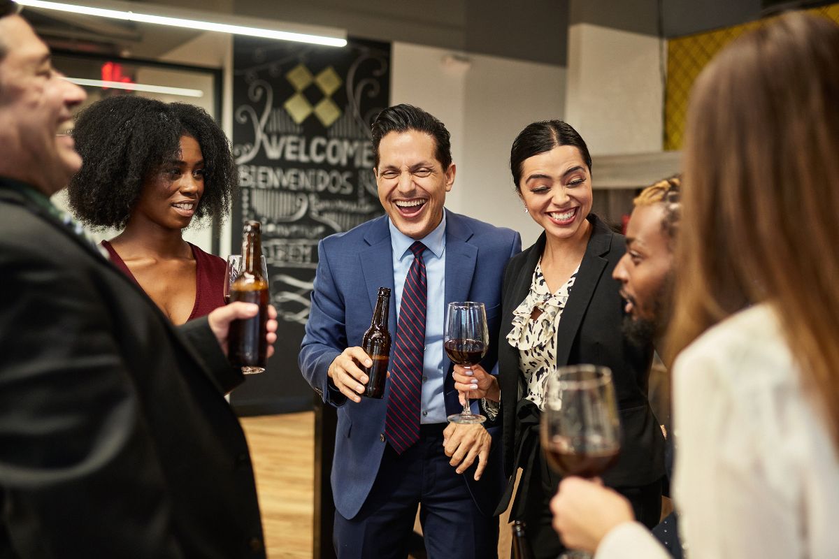 Employees enjoying happy hour in office