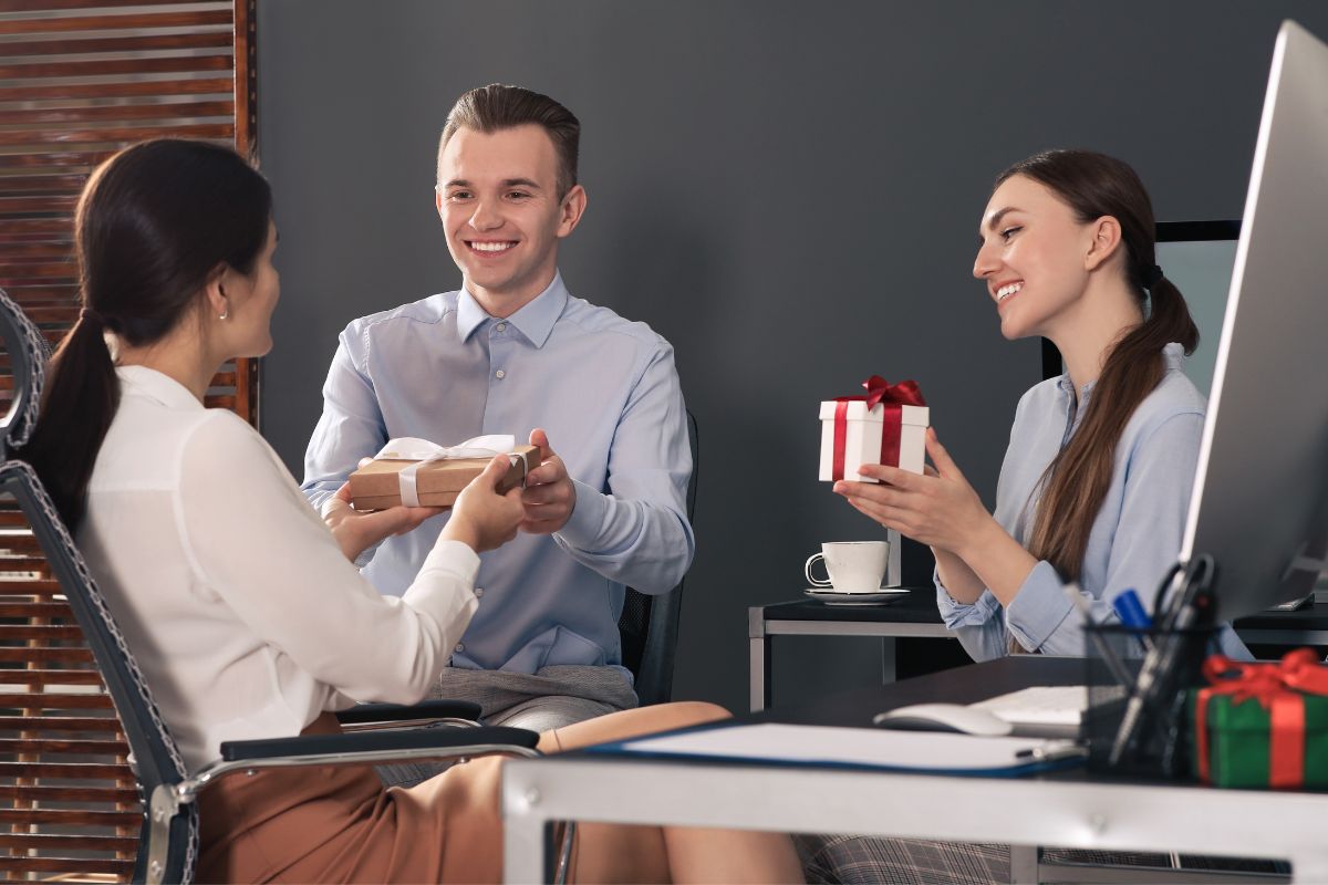 Employees giving gifts to woman in office ordered from swag store online