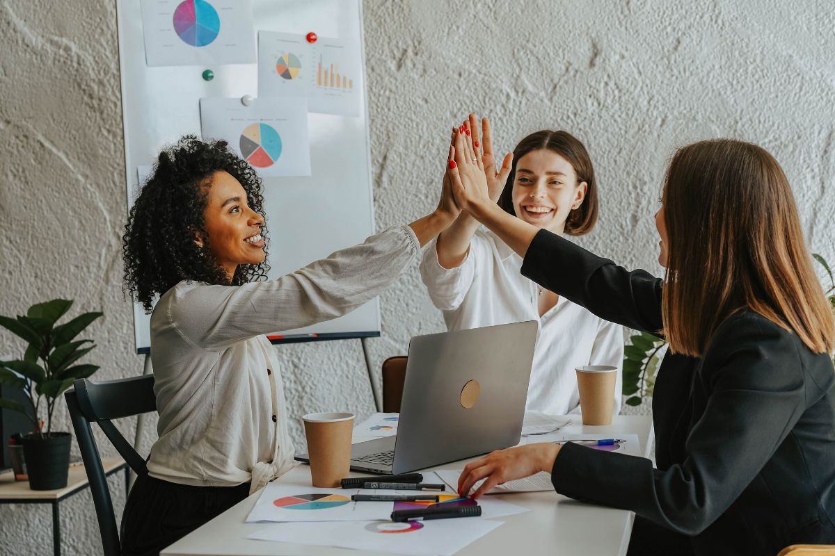 Employees having fun while learning new skills at office with each other.