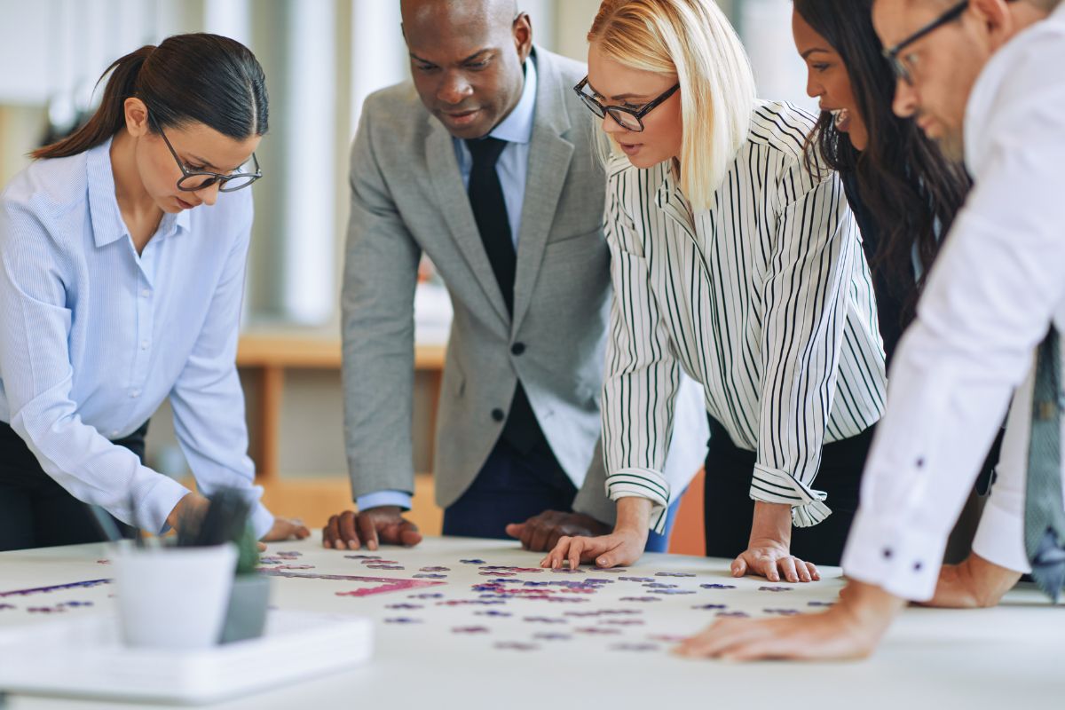 Employees solving puzzle with each other in an engagement activity.