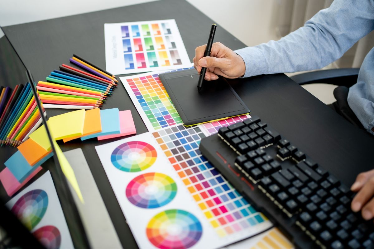 Graphic Designer chooses colors sketches on tablet using hex codes