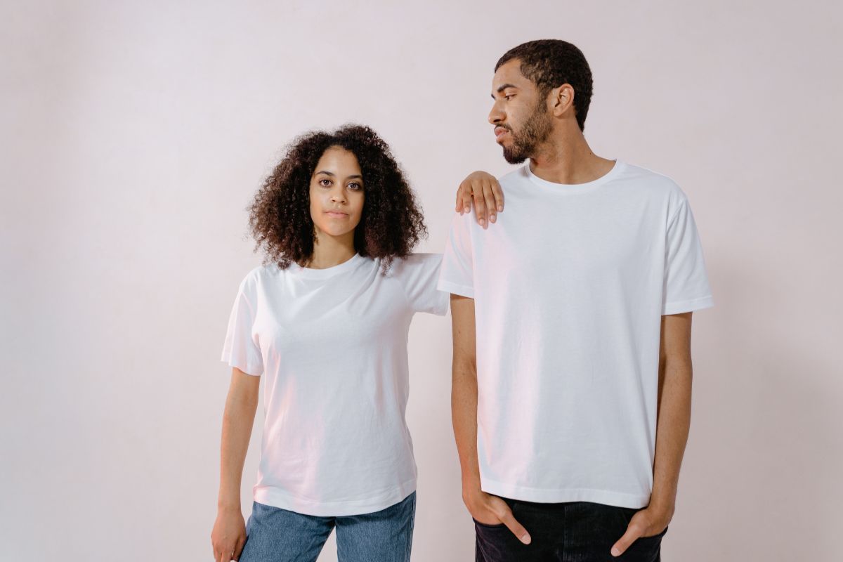 Couple standing models custom t-shirts promoting their t-shirt business