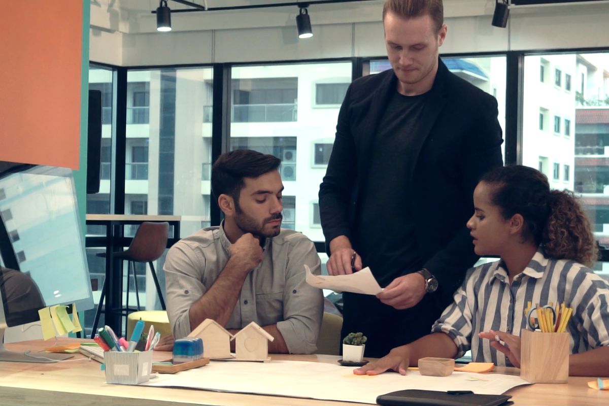 Small business people group discussing about custom swag idea at office desk