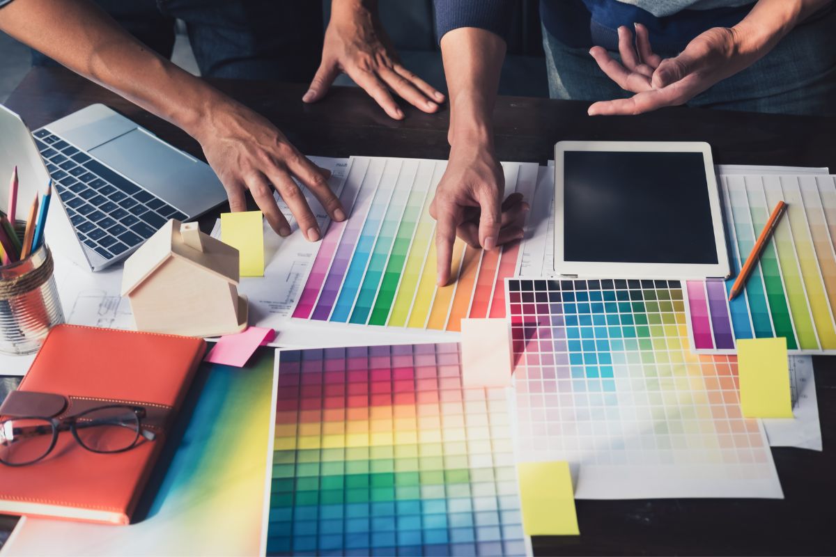 Two men working on color chart to find out how to convert pantone to hex