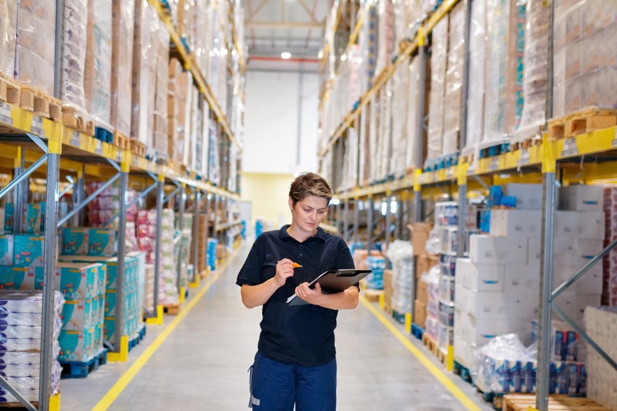 Woman inspecting white label products in a warehouse