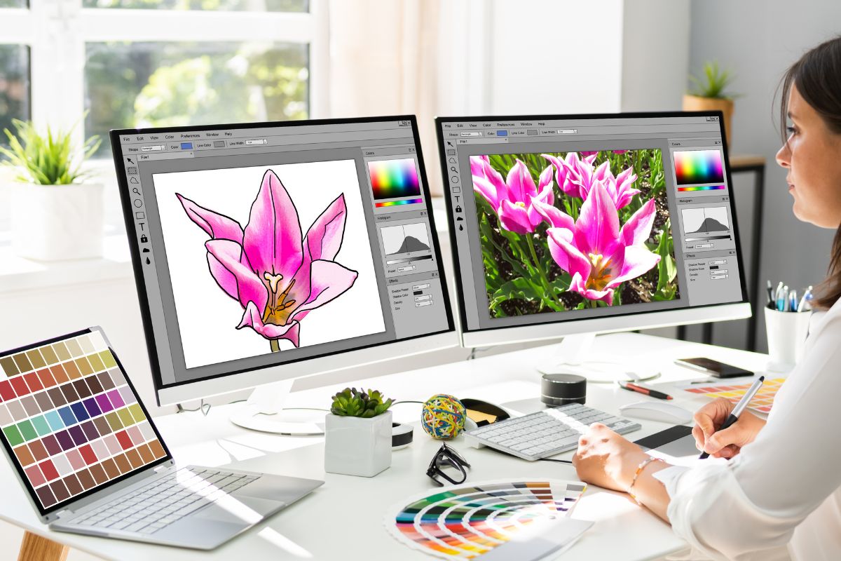 Woman is working on a PNG vector file with two computer screens