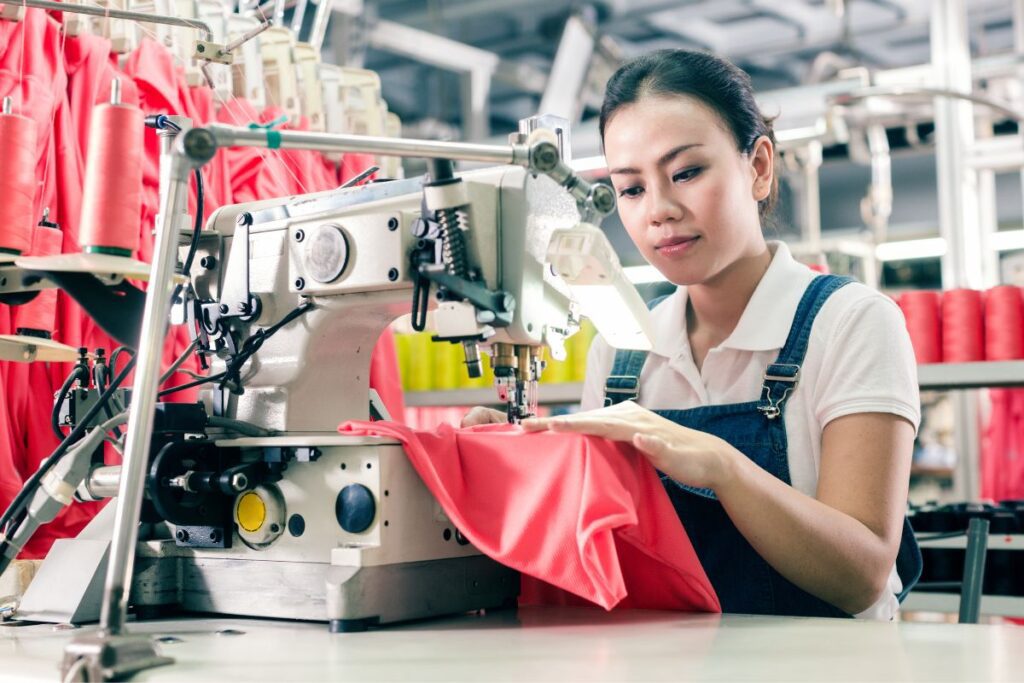 Woman sewing activewear out of polyester fabric