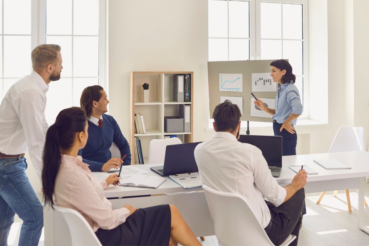 Woman sharing ideas with employees about online swag store