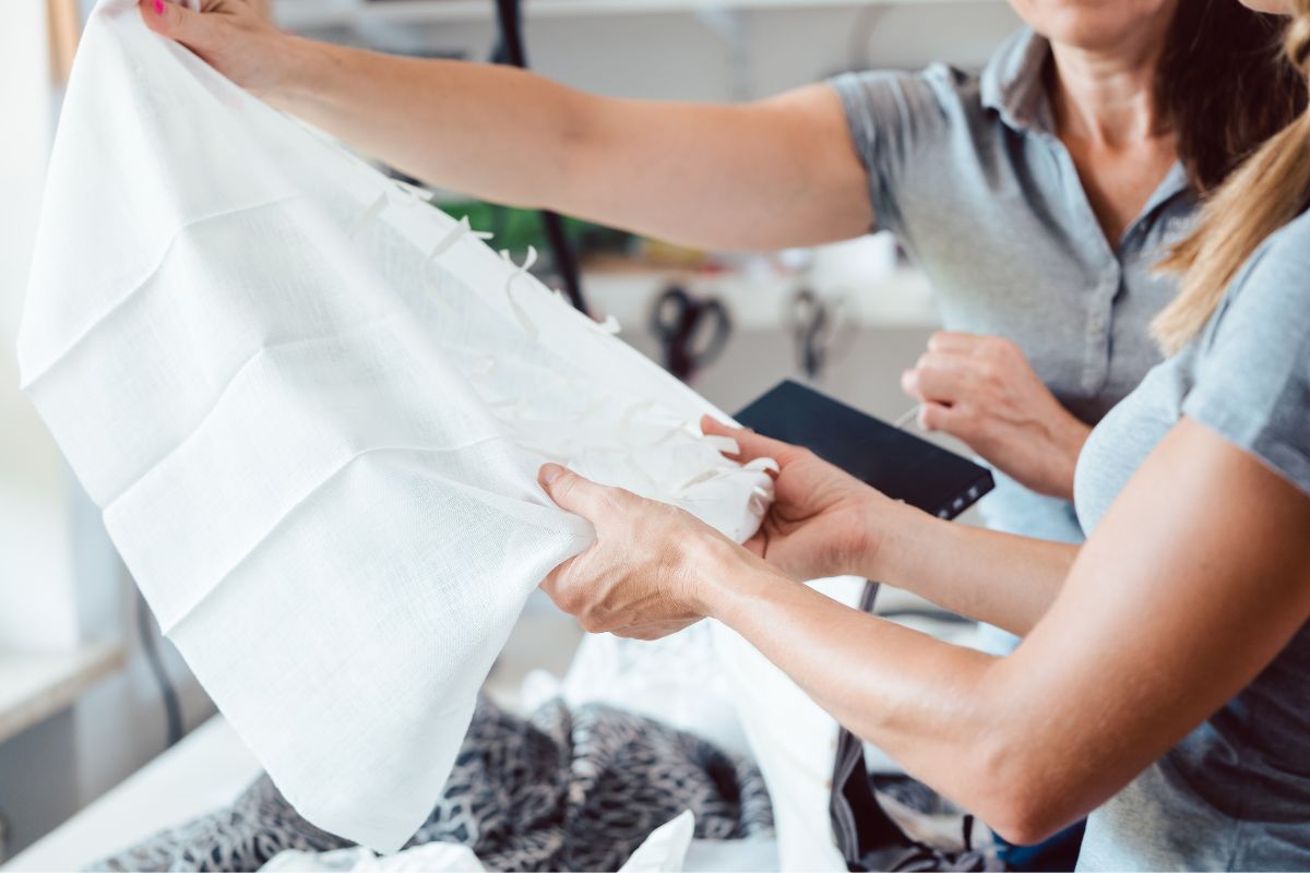 Women inspecting how does polyester fabric feel like