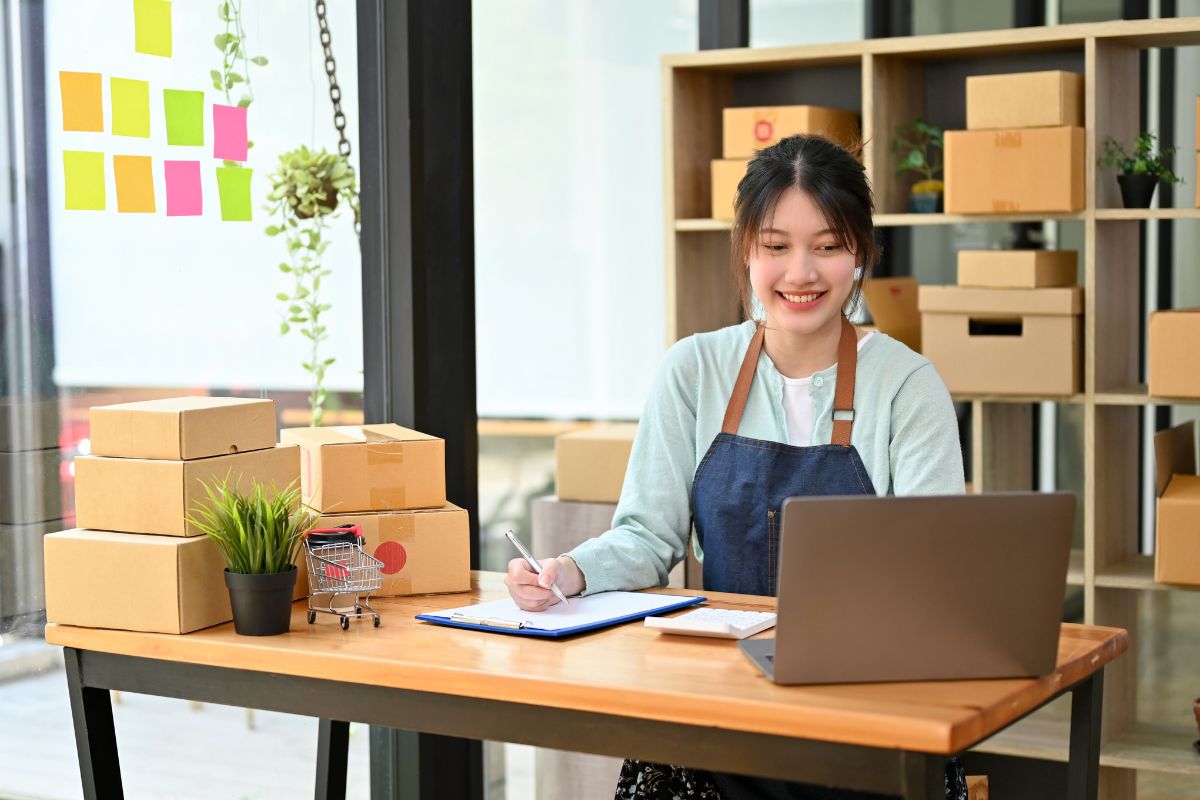 Women with laptop selling things on etsy