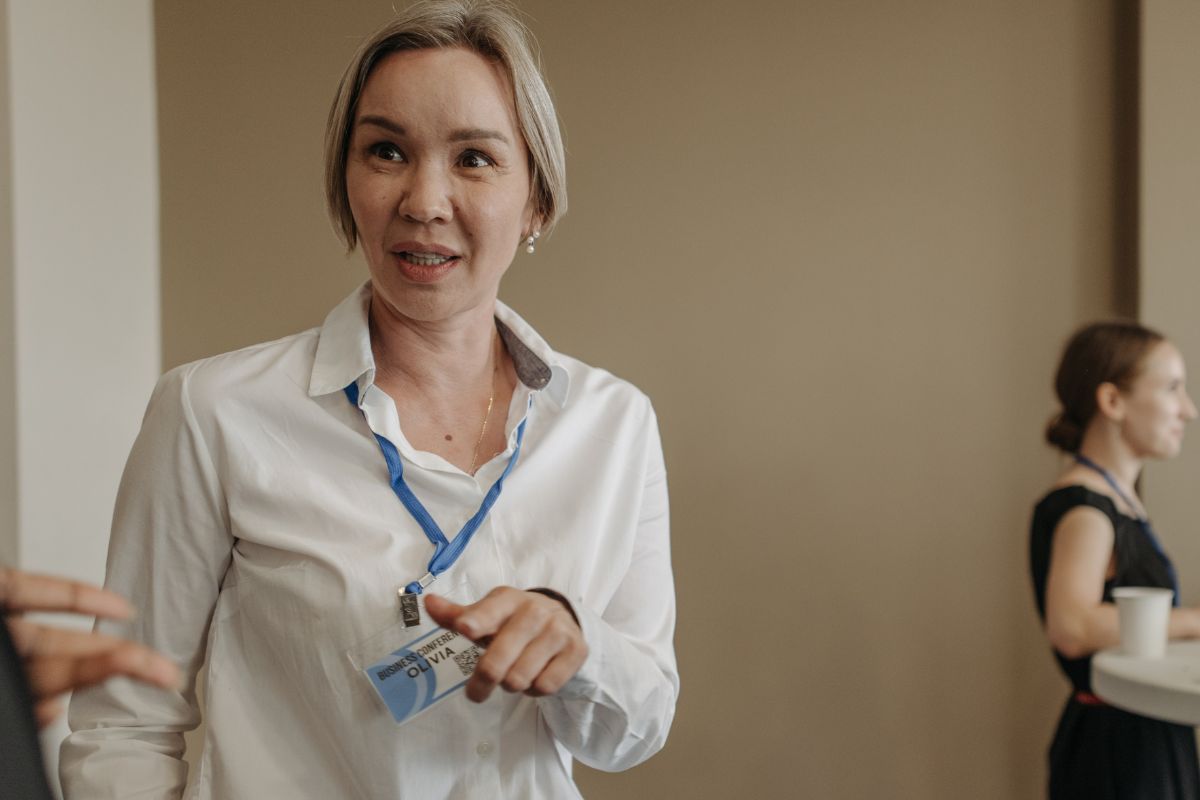 A corporate lady employee wearing a lanyard at the office.