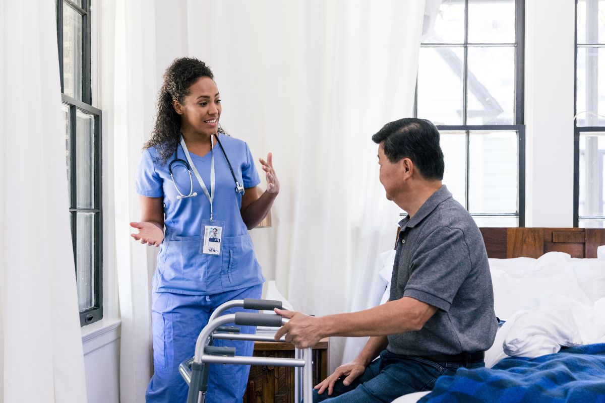 A lady health care advisor wearing a lanyard.