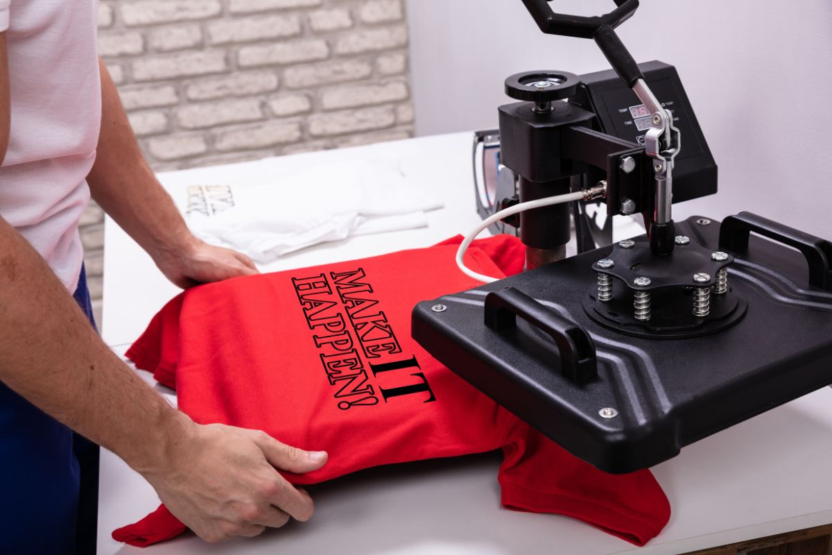A person uses a printing machine to create a trendy design on a t shirt