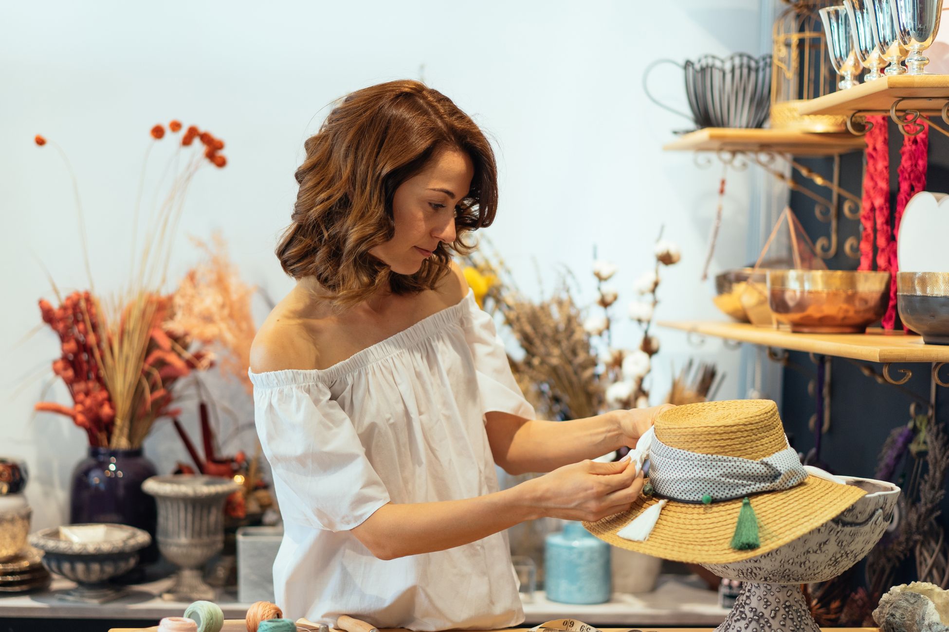 A woman designing a hat