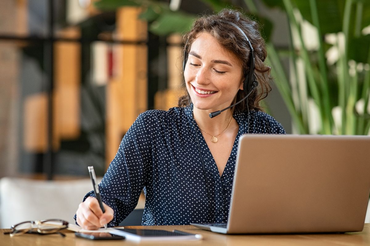 A woman is assisting customers over the phone