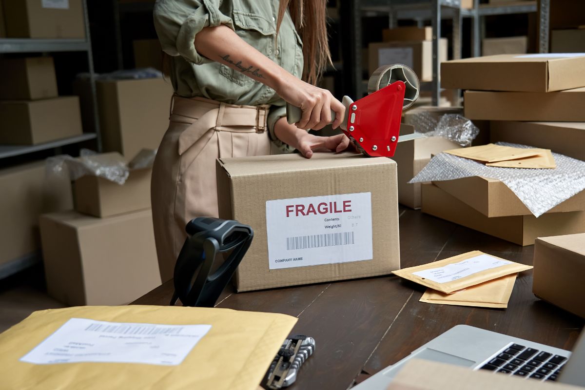 A woman prepares to ship a product in a dropshipping store