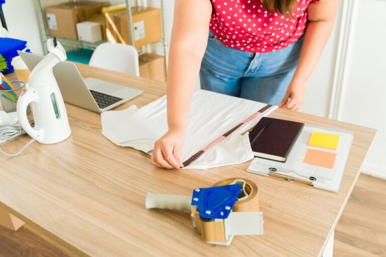 A woman preparing a t shirt for print on demand with an artist focused company