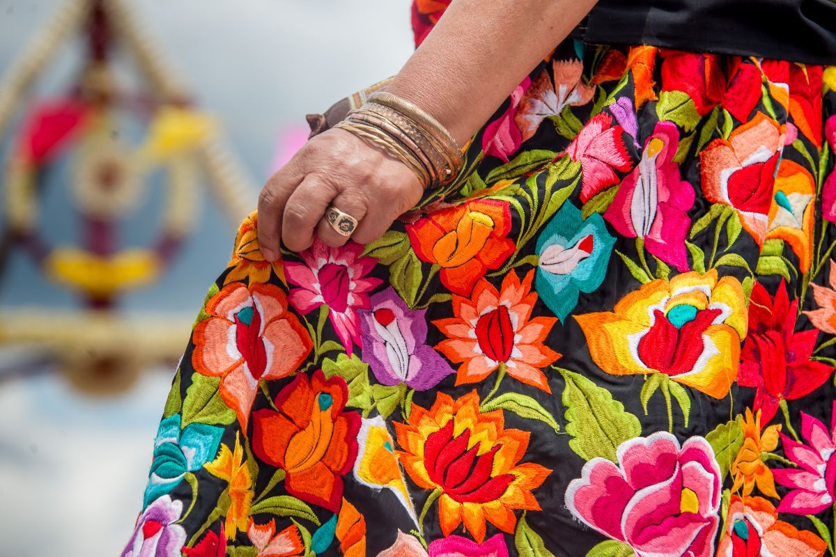 A woman showcasing her embroidered skirt