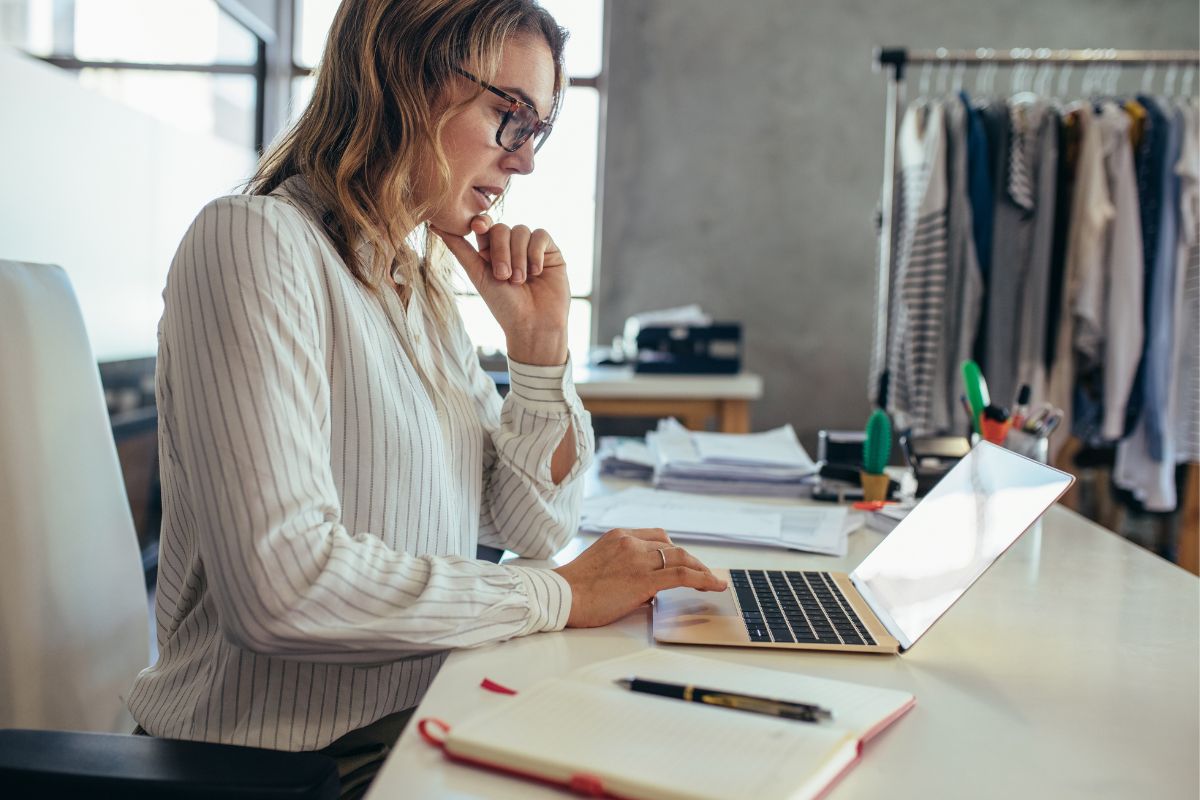 A woman uses a laptop in her office to market dropshipping products