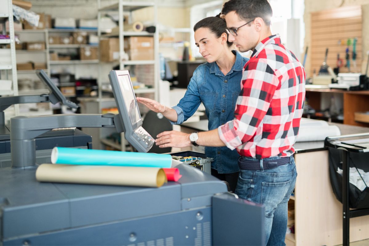 Couple from a print on demand company reviewing dropshipping details on a computer screen