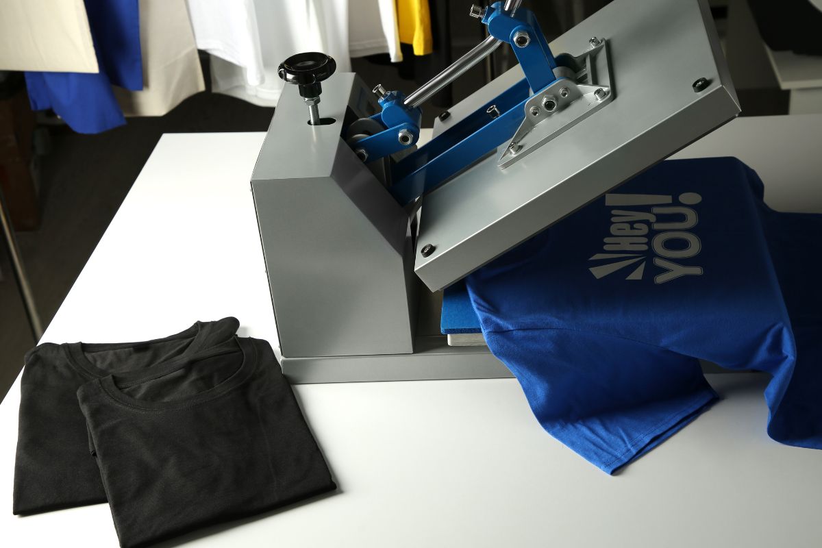 A T-shirt is being printed by a machine in a workshop as a print on demand process