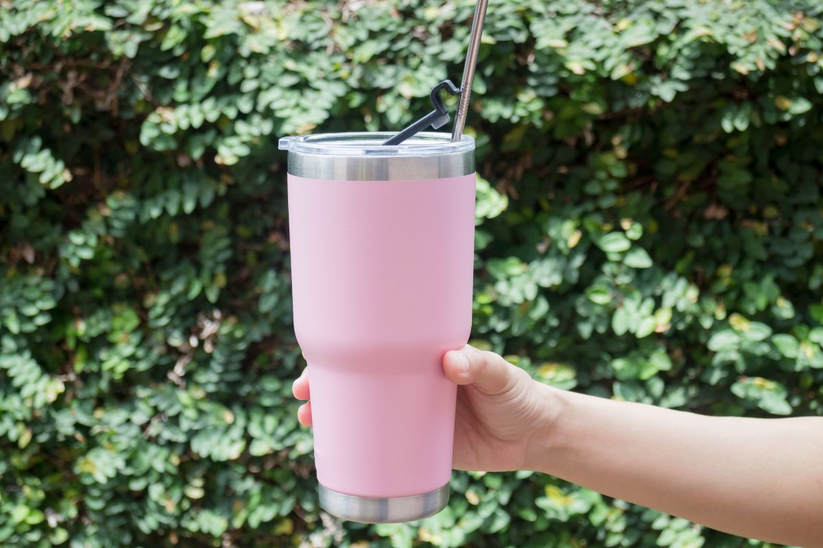 Pink Stainless steel tumbler held in the hand