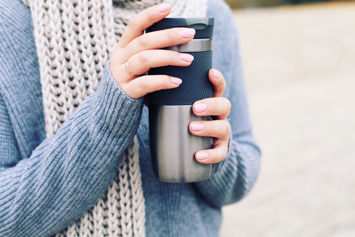 Woman holding a steel tumbler