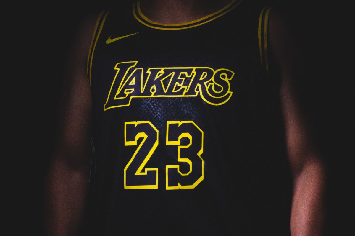A basket ball player jersey showing how logo,team name and number is placed on it.