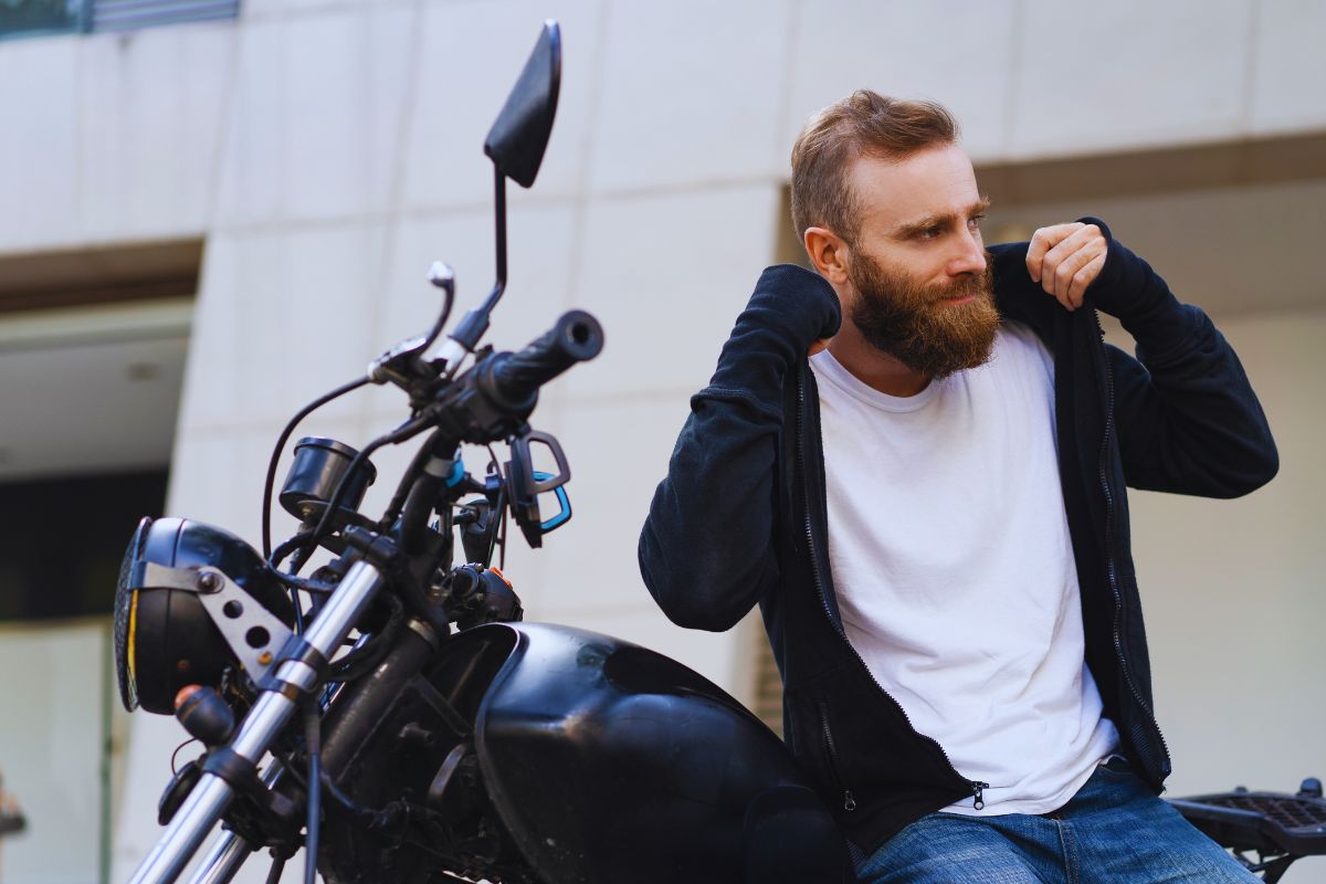 A biker wearing a white tshirt and a black hoodie