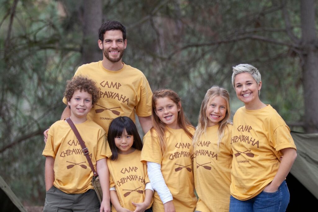 A family wearing camp tshirts