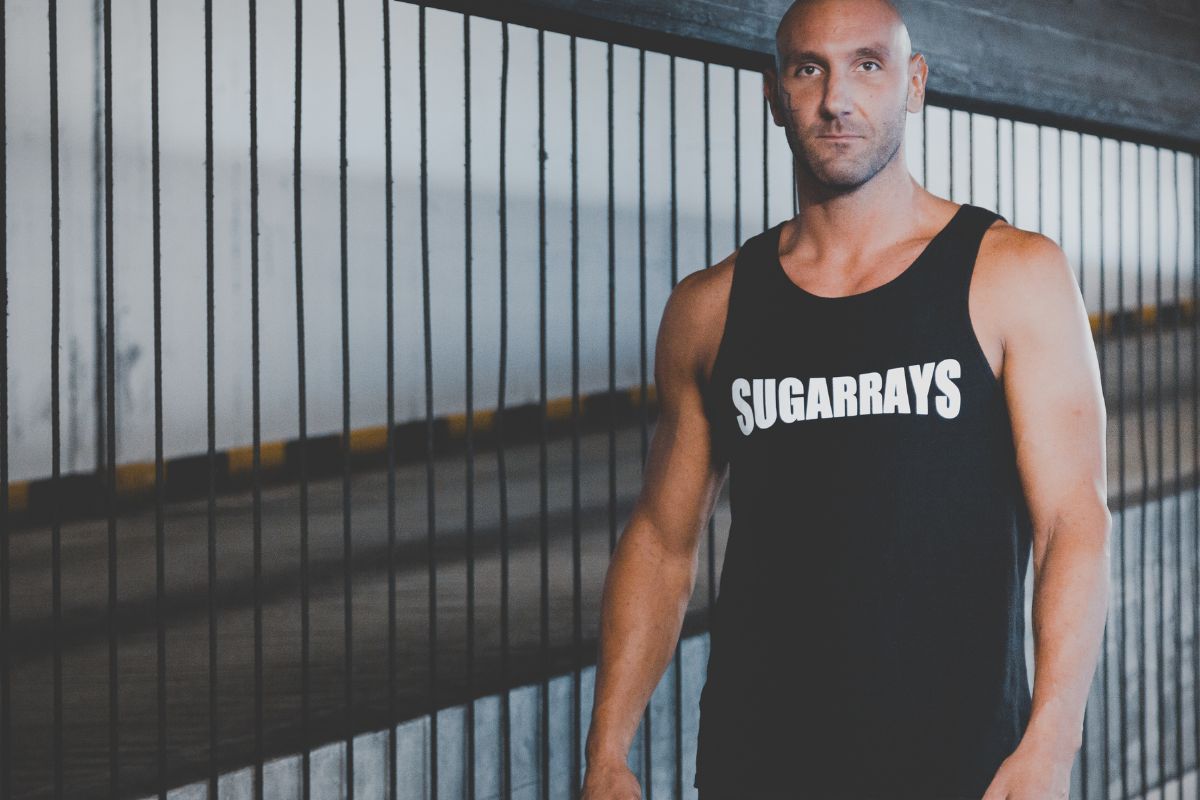 A guy wearing a muscle tank with brand name on it