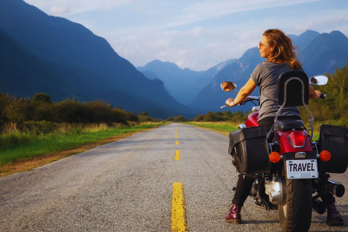 A lady on a motorcycle wearing a Biker T Shirt