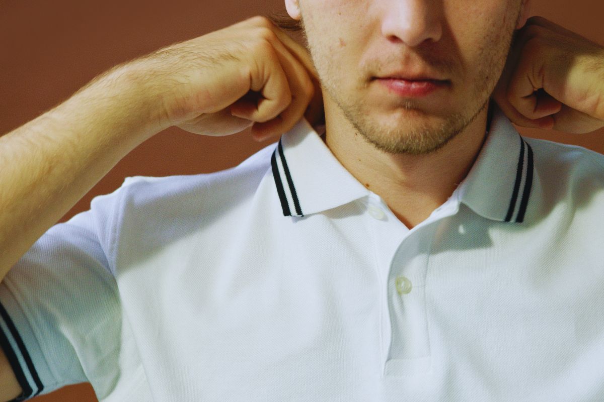 A man wearing a T Shirt with Collar