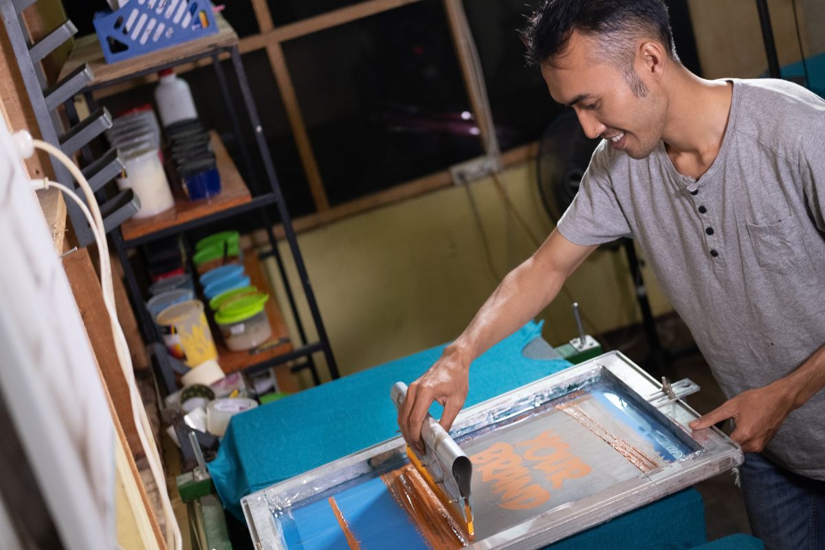 A person using screen printing for t shirt