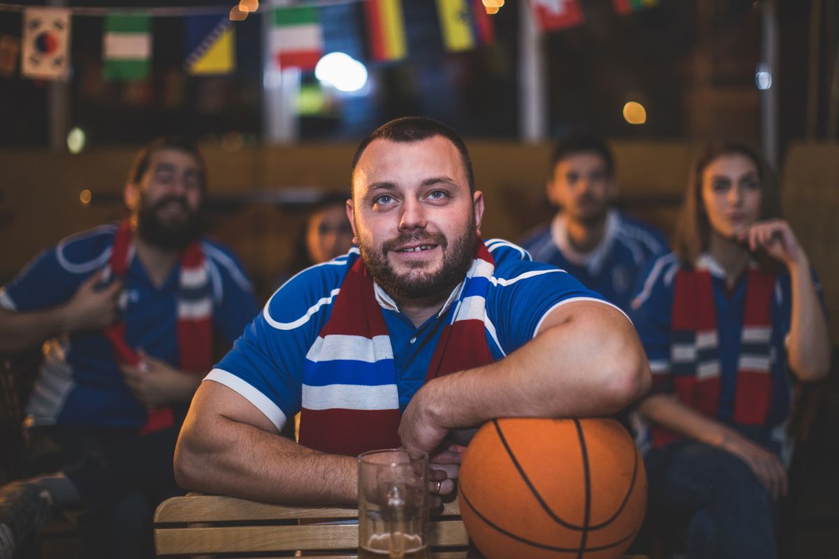 Basket ball fans supporting their team by wearing same team wearable.