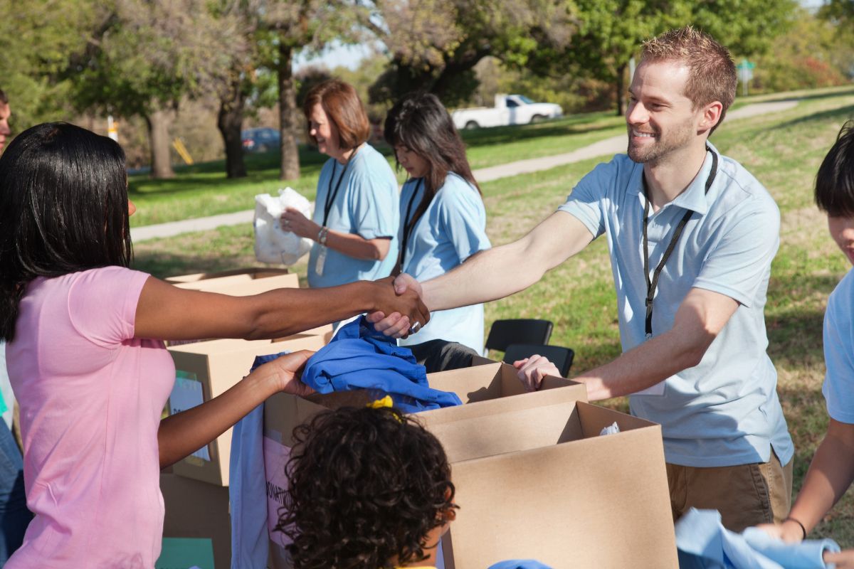 Office employees donating left over items to the poors