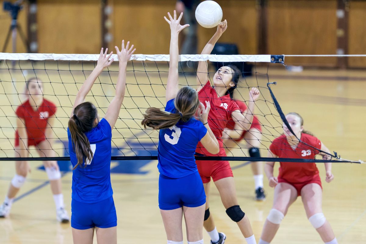 Players playing volleyball while wearing customized t shirts