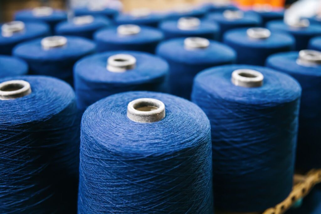 Spool of blue cotton yarn shown in the picture