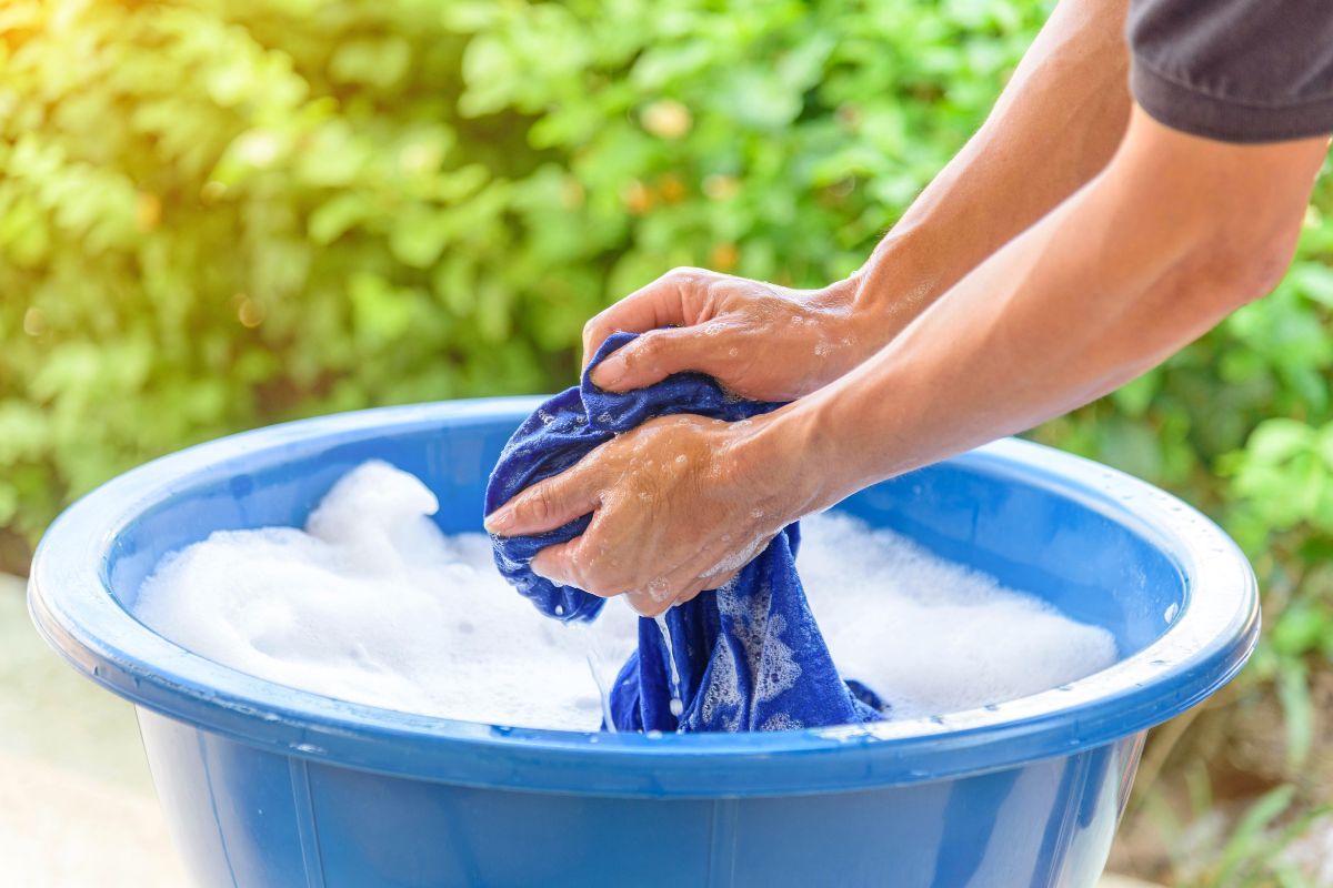 Washing raglan shirt with hands and cold water.