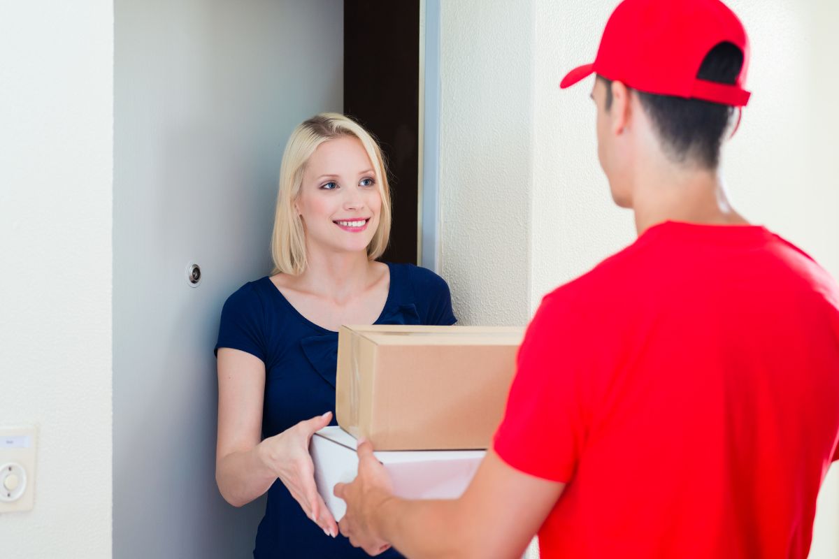 A remote office worker receiving gifts given to her by the office.