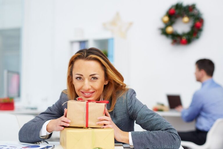 A woman holding gifts for coworkers