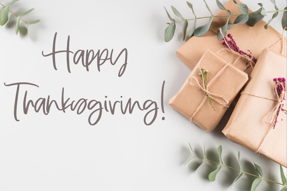 Happy thanksgiving written with some corporate gifts beside it.