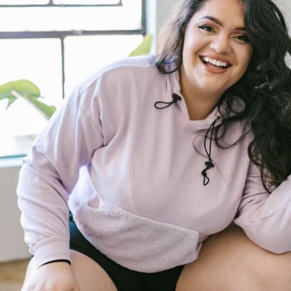 A lady wearing champion hoody made from cotton.