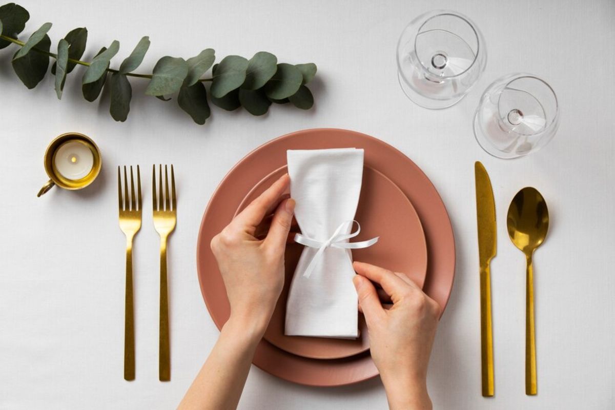 A person folding napkin in different design
