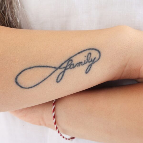 A fading away custom temporary tattoo on a lady's hand